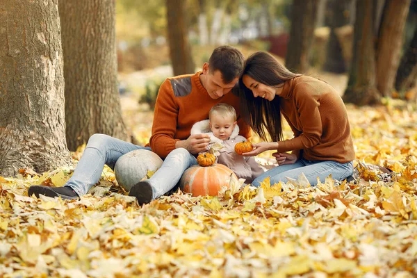 Family with little daughter in a autumn park — Stock Photo, Image