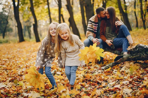 Familie mit niedlichen Kindern in einem herbstlichen Park — Stockfoto