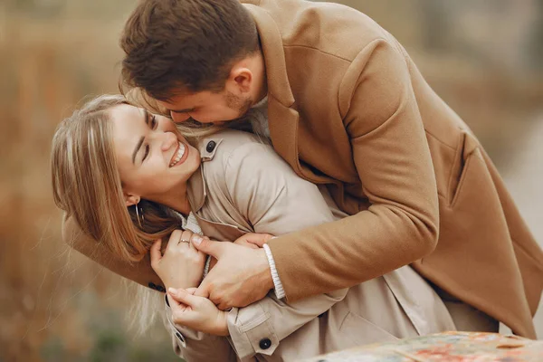 Beautiful couple spend time in a autumn field — Stock Photo, Image