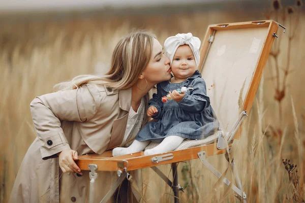 Dívka malování v podzimním poli s matkou — Stock fotografie