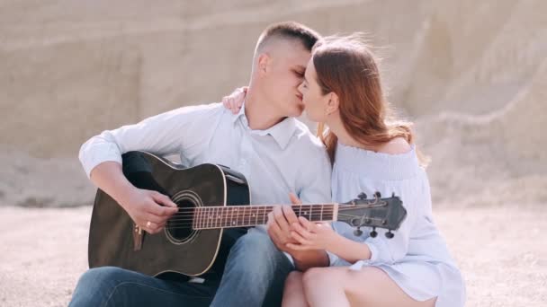 Άντρας κρατώντας κιθάρα και γυναίκα φιλιά στην καριέρα του το καλοκαίρι — Αρχείο Βίντεο