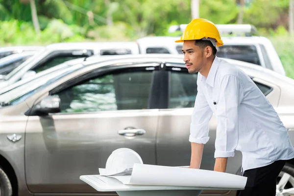 Architect working on blueprint.,engineer inspector in workplace. ,Engineers in helmets planning new project