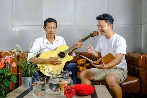 Two friends man playing musical instruments cheerfully