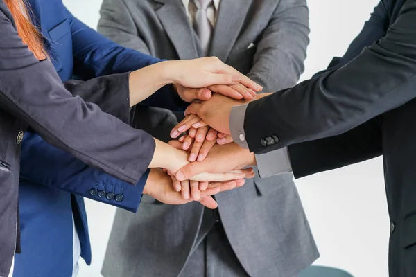 Group of business people meeting shaking hands together, busines