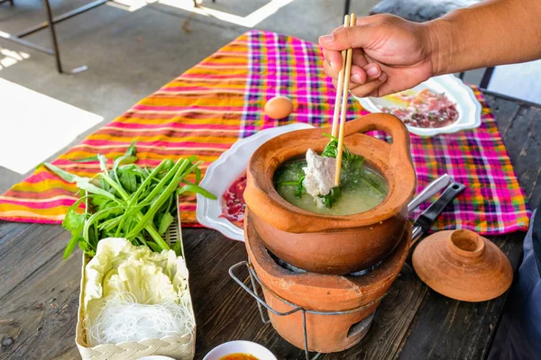 Clay pot Thai traditional spicy shabu shabu, dipping meat in boi — Stock Photo, Image