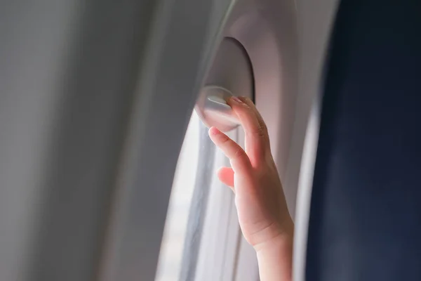 Kid hands on an airplane��s window — Stock Photo, Image