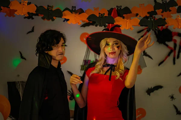 A young man and a girl dress up in scary costumes on a Halloween — Stock Photo, Image