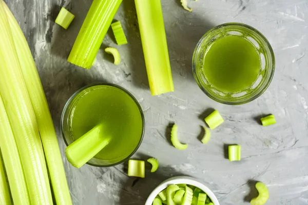 Celery Healthy Green Juice glasses top view on grey background