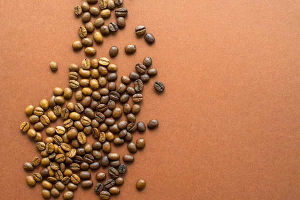 Perfect coffee light and dark roasted beans on brown background close up, flat lay
