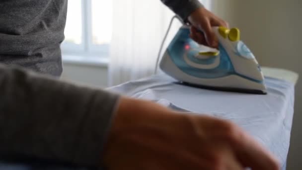 Ironing crumpled shirt on ironing board — Stock Footage Ironing crumpled shirt on ironing board Stock Footage