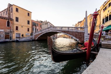 Venedik, İtalya - 1 Ağustos 2020: gondollu Ponte delle Guglie kanalın kenarına demirlemiş