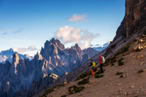 Hikers on the mountain path in the 3 Cime Natural Park (Dolomites World Heritage Site - UNESCO), Italy.