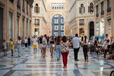 Naples, Italy - September 12, 2025: People stroll inside the majestic Galleria Umberto I, a historic monument.
