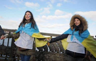 Participants stand as a lively chain at the Paton Bridge for the action on connecting the banks of the Dnieper with a living chain on Unity Day in Kiev 01/22/2017  clipart