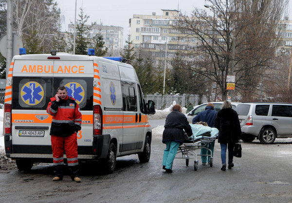 Medical workers transport the patient on a gurney near the hospital of ambulance in Kiev 14.02.2017
