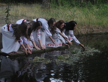 Kızlar Pirogovo Ivan Kupala kutlamaları sırasında suya çelenk koymak, Kiev, Temmuz 6, 2019