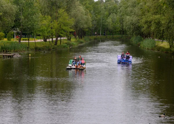 İnsanlar 28 Mayıs 2020 'de Kiev' de gölde katamaranlara biniyor..