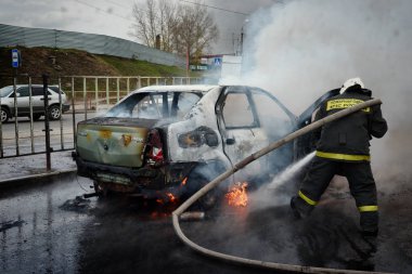 Barnaul, Rusya Federasyonu-Ekim 12, 2018. İtfaiyeciler yanan bir arabadan söndürmek