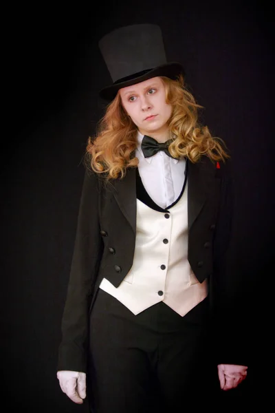 young actress in a tuxedo on the stage of the theater