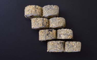 Karanlık bir arka plan üzerinde deniz ürünleri ile Japon rulo