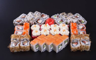 Karanlık bir arka plan üzerinde deniz ürünleri ile Japon rulo