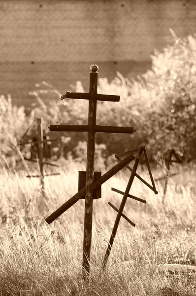 Grave crosses and tombstones stand in the old cemetery in Russia