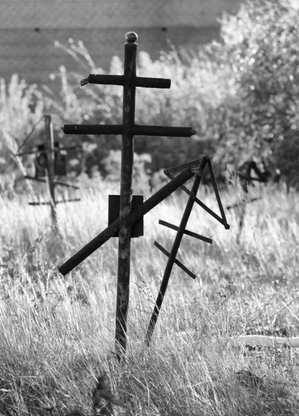 Grave crosses and tombstones stand in the old cemetery in Russia