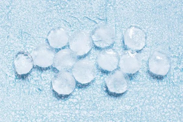 Ice balls on the textured blue table