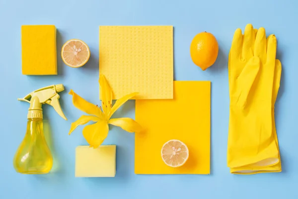 Flat lay composition with cleaning supplies, lemons and flower