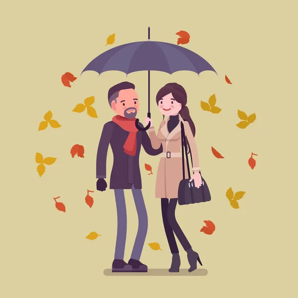 Joven pareja feliz bajo el paraguas en otoño — Vector de stock