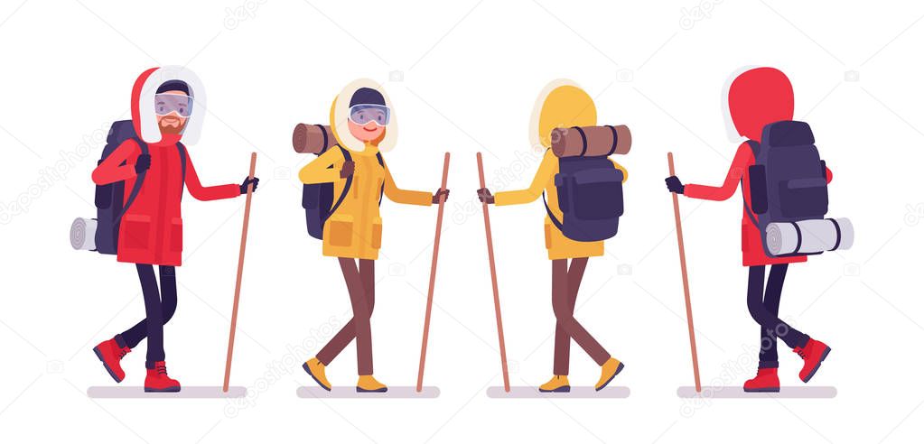 Winter hiking man, woman walk using a stick