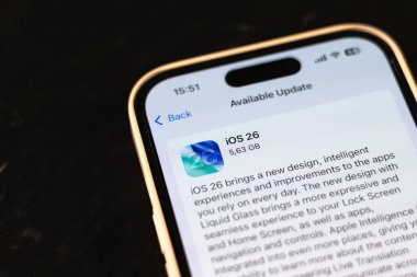 KYIV, UKRAINE - September 15, 2025 : Modern smartphone Apple iPhone with system update purpose. New ios 26 with liquid glass effect. Close up.