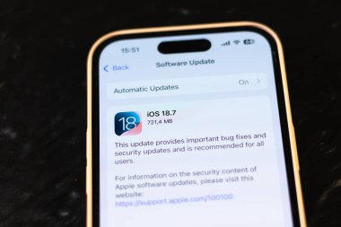 KYIV, UKRAINE - September 15, 2025 : Modern smartphone Apple iPhone with system update purpose. New ios 26 with liquid glass effect. Close up.