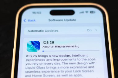 KYIV, UKRAINE - September 15, 2025 : Modern smartphone Apple iPhone with system update purpose. New ios 26 with liquid glass effect. Close up.