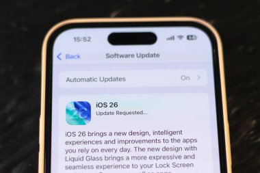 KYIV, UKRAINE - September 15, 2025 : Modern smartphone Apple iPhone with system update purpose. New ios 26 with liquid glass effect. Close up.