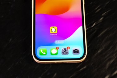 KYIV, UKRAINE - September 15, 2025 : Modern smartphone Apple iPhone with snapchat mobile app. Close up.