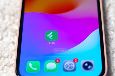 KYIV, UKRAINE - September 15, 2025 : Modern smartphone Apple iPhone with Feedly mobile app. Close up.