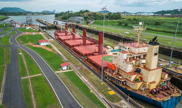 Large cargo ships pass through the Panama Canal locks.  This everyday event, provides income from both fees and tourism for the whole country. 