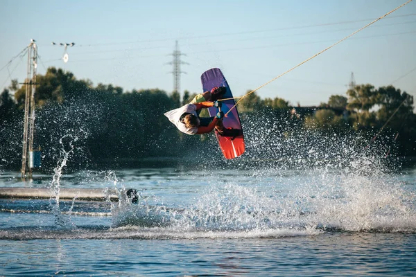 Wakeboarder makes an extreme jump. Sport and active lifestyle.