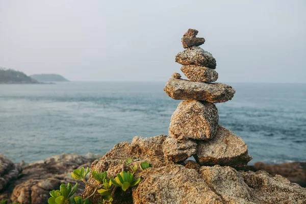 Zen rock tower on sea cost morning sunrise time. Nature landscape photography