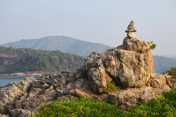 Zen rock tower on sea cost morning sunrise time. Nature landscape photography