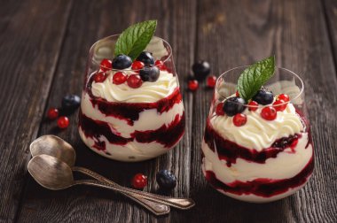 Siyah arka plan üzerine Berry mascarpone köpüğü tatlı.