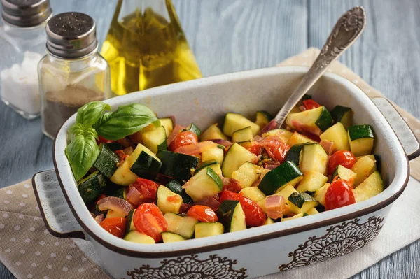 Sauteed zucchini with tomatoes and red onion.