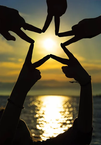 Many Hands Connecting Star Shape Sunset Teamwork Concept Stock Image