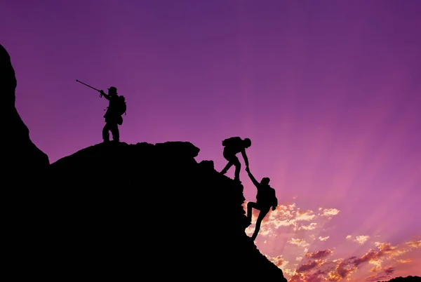 Hikers Climbing Rock Mountain Sunset One Them Giving Hand Helping Royalty Free Stock Photos