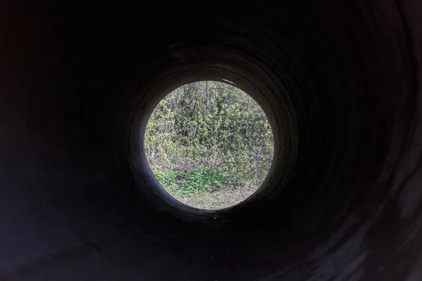 View on river bank from steel pipe.