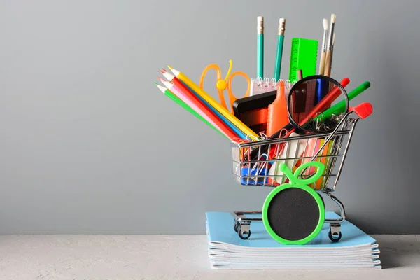 Shopping cart with stationery on notebooks