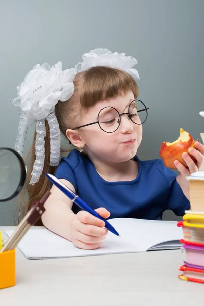 Female Kid Glasses White Bows Smiling Fruit Doing Homework Blue — Stock Photo, Image
