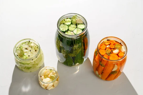 Comida vegana saludable. Hortalizas fermentadas caseras pepinos, zanahorias, repollo y ajo en frascos de vidrio. —  Fotos de Stock