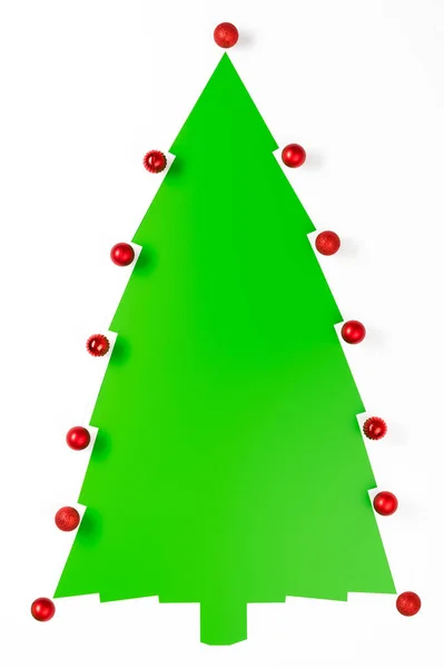 Alternative Christmas tree. Top view of a Christmas tree made from white sheets of paper on a green background. — Stock Photo, Image